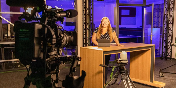 Photo: A female student is preparing to present the news on TV.