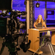 Photo: A female student is preparing to present the news on TV.