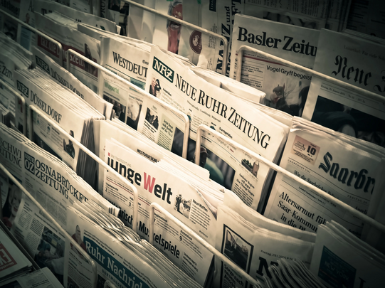Photo: A variety of German newspapers are displayed at a newspaper stand.