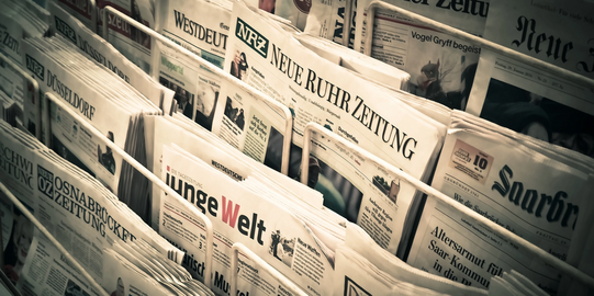 Photo: A variety of German newspapers are displayed at a newspaper stand.