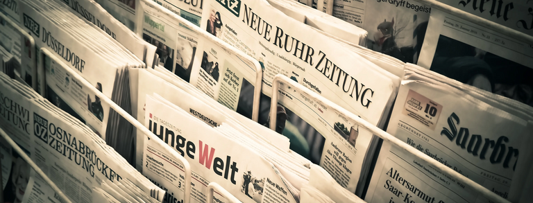Photo: A variety of German newspapers are displayed at a newspaper stand.