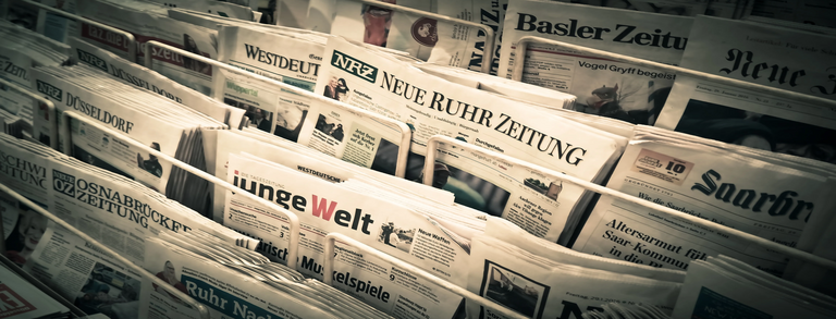Photo: A variety of German newspapers are displayed at a newspaper stand.