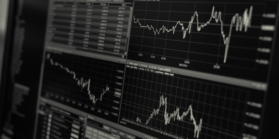 Photo: Close-up of a computer monitor with visualization and diagrams of stock market movements.