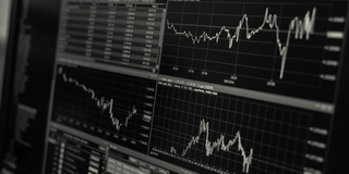 Photo: Close-up of a computer monitor with visualization and diagrams of stock market movements.
