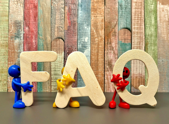 Photo: Beige bold letters F, A and Q are held by small figurines in blue, yellow and red 