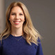 Photo: Profile picture of Olga Scheer. She has shoulder-long blond hair and is wearing a dark blue pullover.