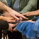 Photo: Hands of various skin colours meet in the middle