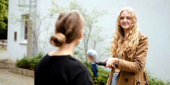 Photo: Two female students are practicing a TV interview situation.