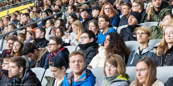 First semester students sit in the stands at the stadium during the welcoming of first-semester students.