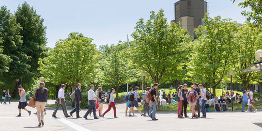 People are walking across the North Campus.
